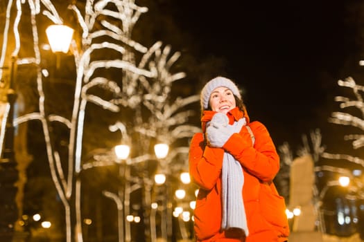 pretty funny girl having fun outdoor in winter. Christmas, city and winter holidays concept.