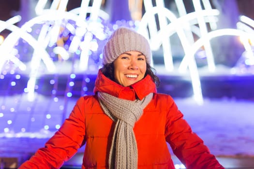 Girl in a night city snowflake Christmas city lights. Christmas and winter holidays.