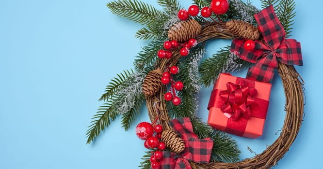 Christmas decor, gifts wrapped in red paper on a blue background, top view. Copy space