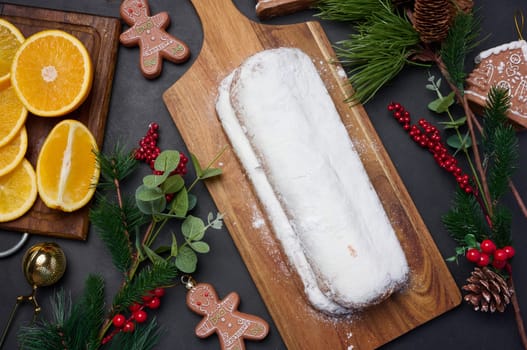 Christmas pastries stollen sprinkled with powdered sugar on the table, festive dessert