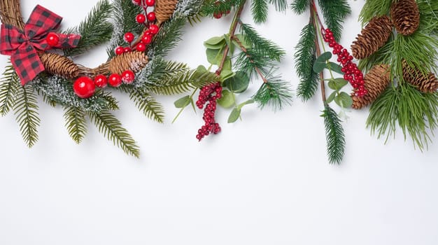 Christmas fir branches with decor on a white background, top view. Copy space
