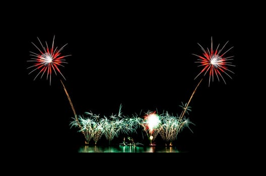 Beautiful fireworks display on black sky with copy space for greeting text. Celebration and anniversary concept