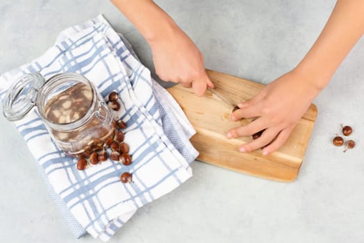 Preparing chestnut liquid soap, cutting buckeye and putting it into a jar with water, alternative homemade detergent for washing clothes