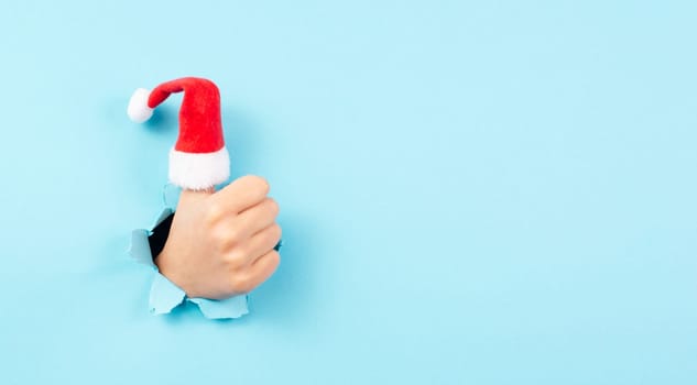 Thumb up, Santa Claus hat, Christmas holiday, positive hand gesture, optimism and emotion, winter season