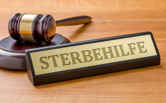 A gavel and a name plate with the engraving Euthanasia in german - Sterbehilfe