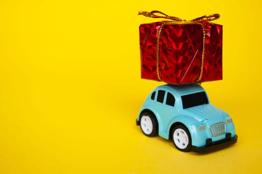 Toy car carrying present in red with customizable space for text.