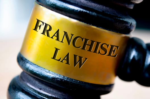 Franchise law text engraved on gavel. Franchise law and legal concept.