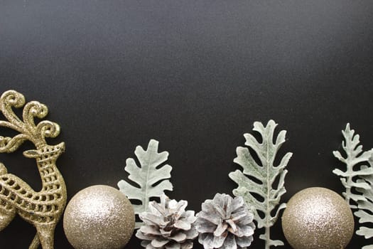 New Year's silver decorations on a black background with space for text