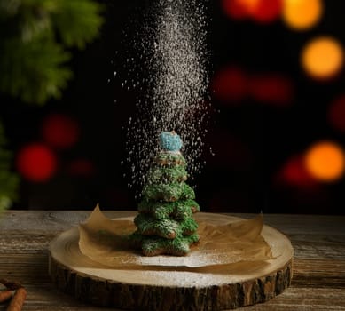 Christmas composition. Gingerbread spruce. Christmas wreath. Against the background of blurred festive garlands.selective focus. High quality photo.