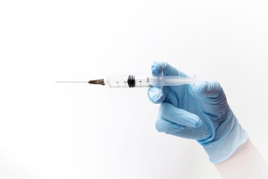 hand of a nurse in nitrile blue gloves holds a syringe with a medicine. selective focus. isolated on white background