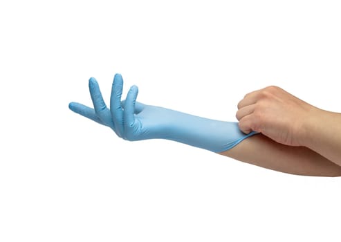 hand puts on blue disposable medical gloves isolated on white background. Infection control concept.