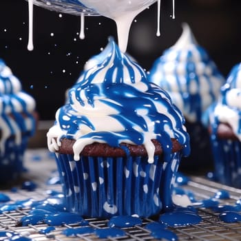 pastry chef pours white icing on delicious appetizing cupcake with blue cream .