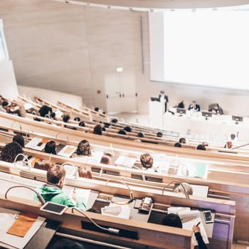 Conference and Presentation. Audience at the conference hall. Business and Entrepreneurship. Faculty lecture and workshop. Audience in the lecture hall. Academic education. Student making notes.