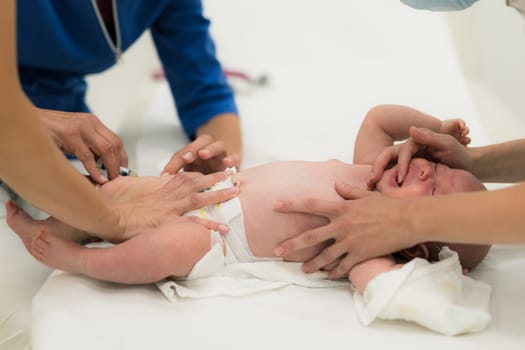Baby beeing vaccinated by pediatrician in presence of his mother. Preventive vaccination against Diphtheria, whooping cough, tetanus, hepatitis, haemophilus influenzae, pneumococcus, poliomyelitis.