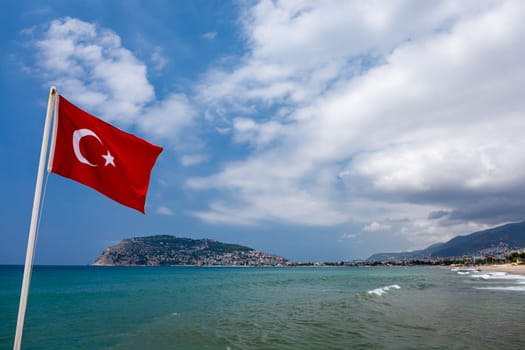 Alanya beach in Turkey, national flag of Turkey, travel landscape