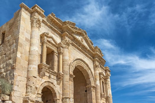 Side view of the Arch of Hadrian with blue sky in the background at archaeological site in Gerasa (Jerash.). Jordnan. Horizontally.