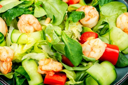 Plate with appetizing shrimps salad with green lettuce. Salad of shrimp or prawns. Healthy eating.