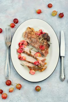 Delicious grilled beef steak with gooseberry.