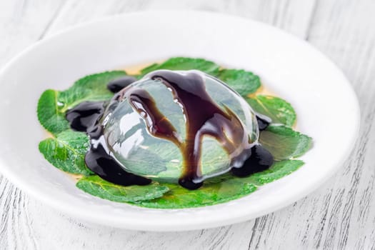 Portion of raindrop cake on mint leaves bad