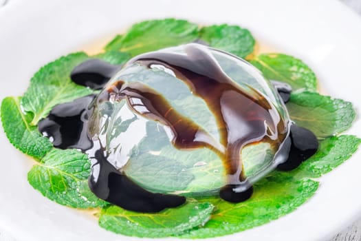 Portion of raindrop cake on mint leaves bad