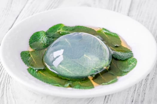 Portion of raindrop cake on mint leaves bad