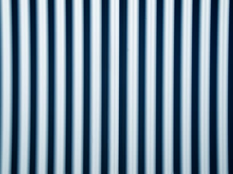 Full format view of a series of pipes arranged evenly in parallel and vertically.