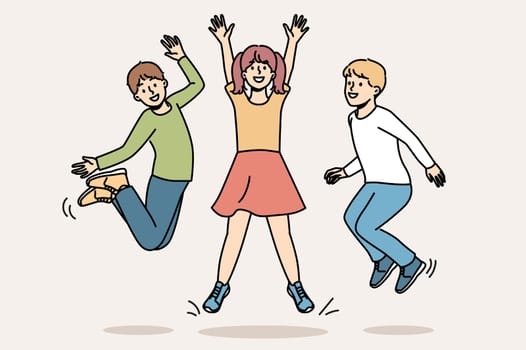 Cheerful children jumping together and enjoying life symbolize happy childhood and lack of worries in adolescence. Children boys and girls having fun enjoying vacation or weekend at school
