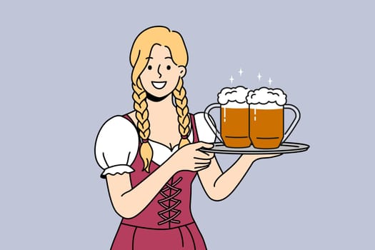 Woman waiter with beer on tray smiles, inviting to visit bavarian autumn festival to try alcoholic drinks. Two mugs with foamy ale or beer from bar in hands of girl serving guests at holiday party