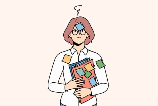 Confused woman student with stickers on face and shirt needs ability to do task management. Girl teacher holds folders with documents and suffers due to excessive pressure from university management