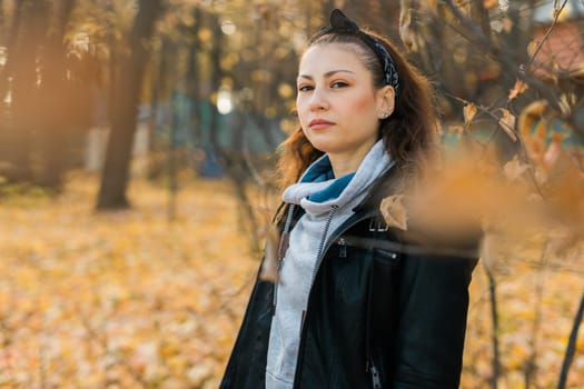 Outdoor atmospheric lifestyle portrait of young beautiful young woman copy space. Warm autumn fall season. Millennial generation and youth.