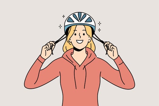 Woman cyclist puts protective helmet on head before cycling to protect against injuries from falls. Girl lover cycling advocates use of hardhat to avoid accidents that could lead to hospitalization.