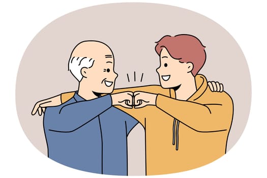 Happy grandfather and grandson give fists bump