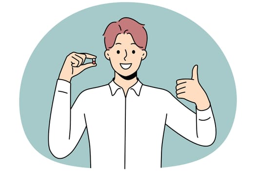 Smiling young man holding pill in hands showing thumb up. Happy male with tablet recommend treatment. Antidepressant or painkiller. Vector illustration.