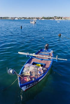 small rowing boat with fishing nets on board on the adriatic sea