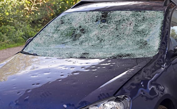 Hail damage to a car. Large hailstones have completely destroyed a car
