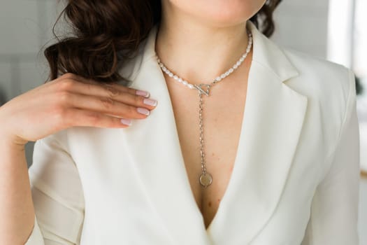 Woman's decollete with a luxury jewelry. Unusual and elegant pendant. Close up shot of beautiful pendant with crystals. Women Accessories