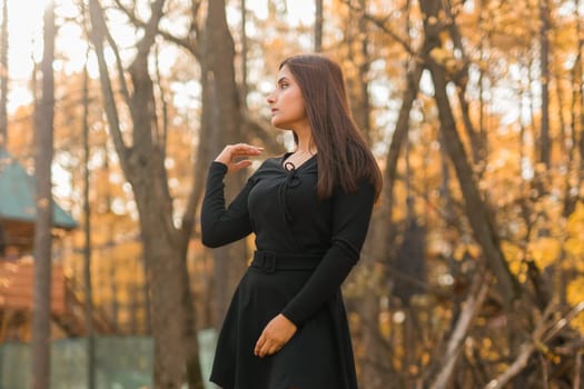 Close up portrait of pretty indian young woman enjoying warm autumn sunny day vacation outdoors. Generation z and gen z concept. Fall Season.