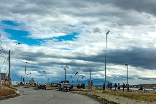 Unidentified pedestrians on the waterfront in Puerto Natales, Patagonia, Chile