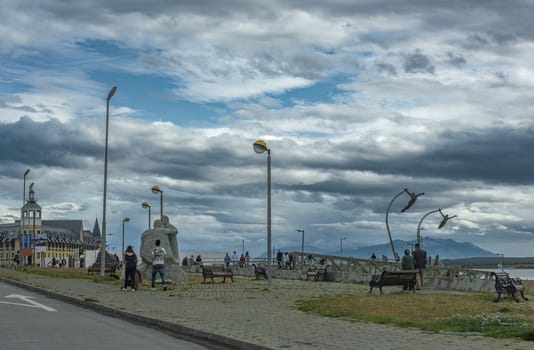 Unidentified pedestrians on the waterfront in Puerto Natales, Patagonia, Chile