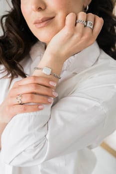 Women Jewelry concept. Woman's hands close up wearing rings and necklace modern accessories elegant lifestyle.