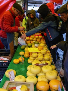 Gouda, the Netherlands - April 20, 2023: Traditional Dutch Gouda cheese at a street stall on Thursday traditional cheese market  day in Gouda, the Netherlands