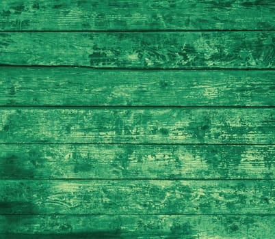 Very weathered wooden wall with green old planks