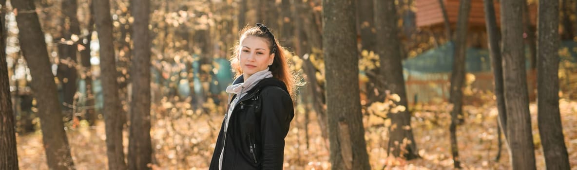 Outdoor atmospheric lifestyle portrait of young beautiful young woman copy space. Warm autumn fall season. Millennial generation and youth.