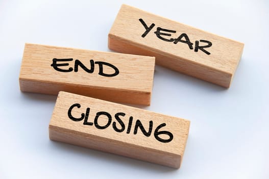 Top view of Year End Closing text on wooden blocks. Year end closing concept.