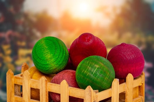 Air freshener. A small wooden box with various wooden balls scented with essential oils in front of a blurred abstract forest.  Fresh aroma just like in a natural forest. Nice gift.