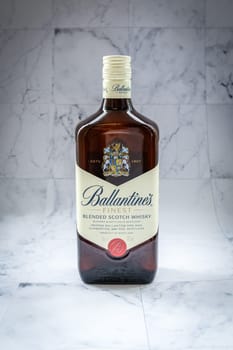 Lyon, FRANCE - JUNE 7, 2023: Ballantines whisky on gradient background. Ballantines is blended scotch whisky produced produced by Pernod Ricard in Dumbarton, Scotland.