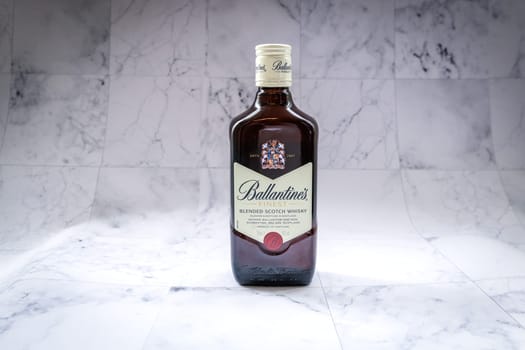 Lyon, FRANCE - JUNE 7, 2023: Ballantines whisky on gradient background. Ballantines is blended scotch whisky produced produced by Pernod Ricard in Dumbarton, Scotland.
