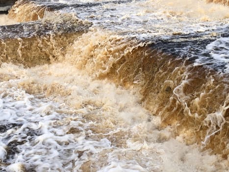 waterfall, the stream of water breaks into billions of splashes, seethes and foams, view from above