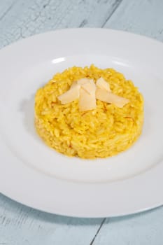 Portion of saffron risotto on the white plate