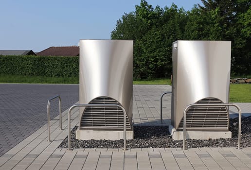 Modern heat pumps for heating in front of a house